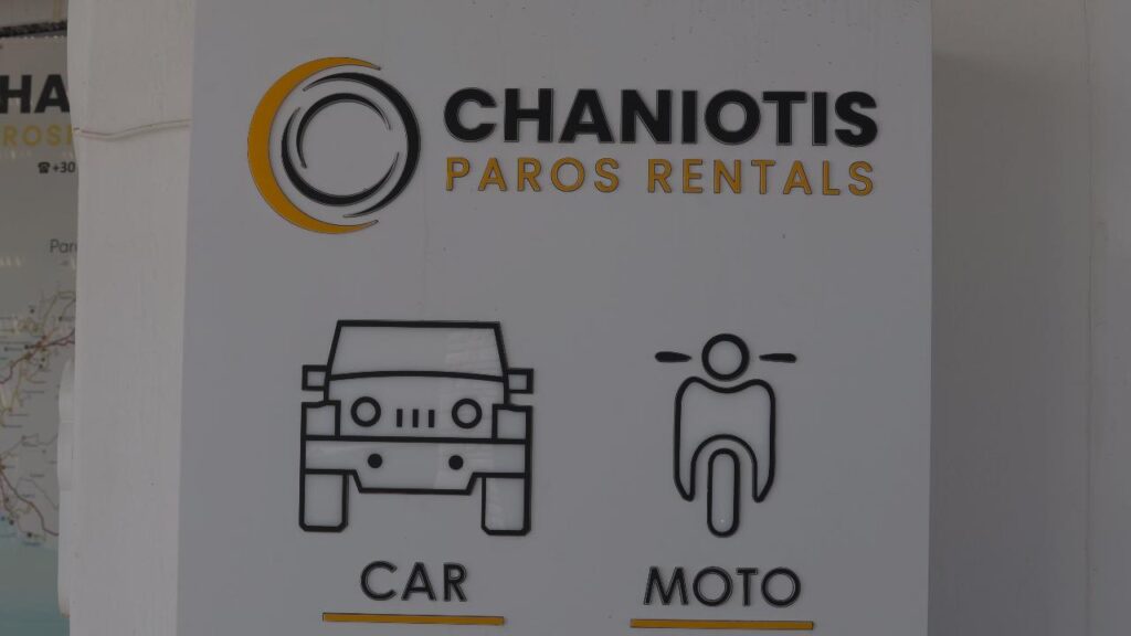Sign for Chaniotis Paros Rentals with car and motorcycle icons labeled CAR and MOTO beneath the logo.