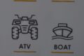 Line-drawn ATV icon labeled ATV on the left and a boat icon with waves labeled BOAT on the right.