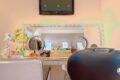 Nail salon station with twin circular mirrors, bright ring lights, and manicure supplies on the counter.