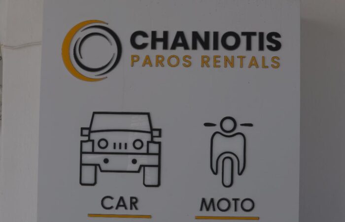 Sign for Chaniotis Paros Rentals with car and motorcycle icons labeled CAR and MOTO beneath the logo.